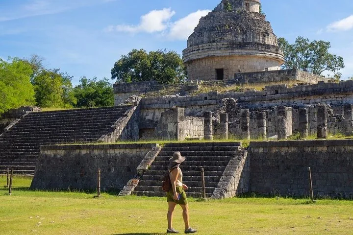 A woman walks toward El Caracol observatory ruins at Chichén Itzá.